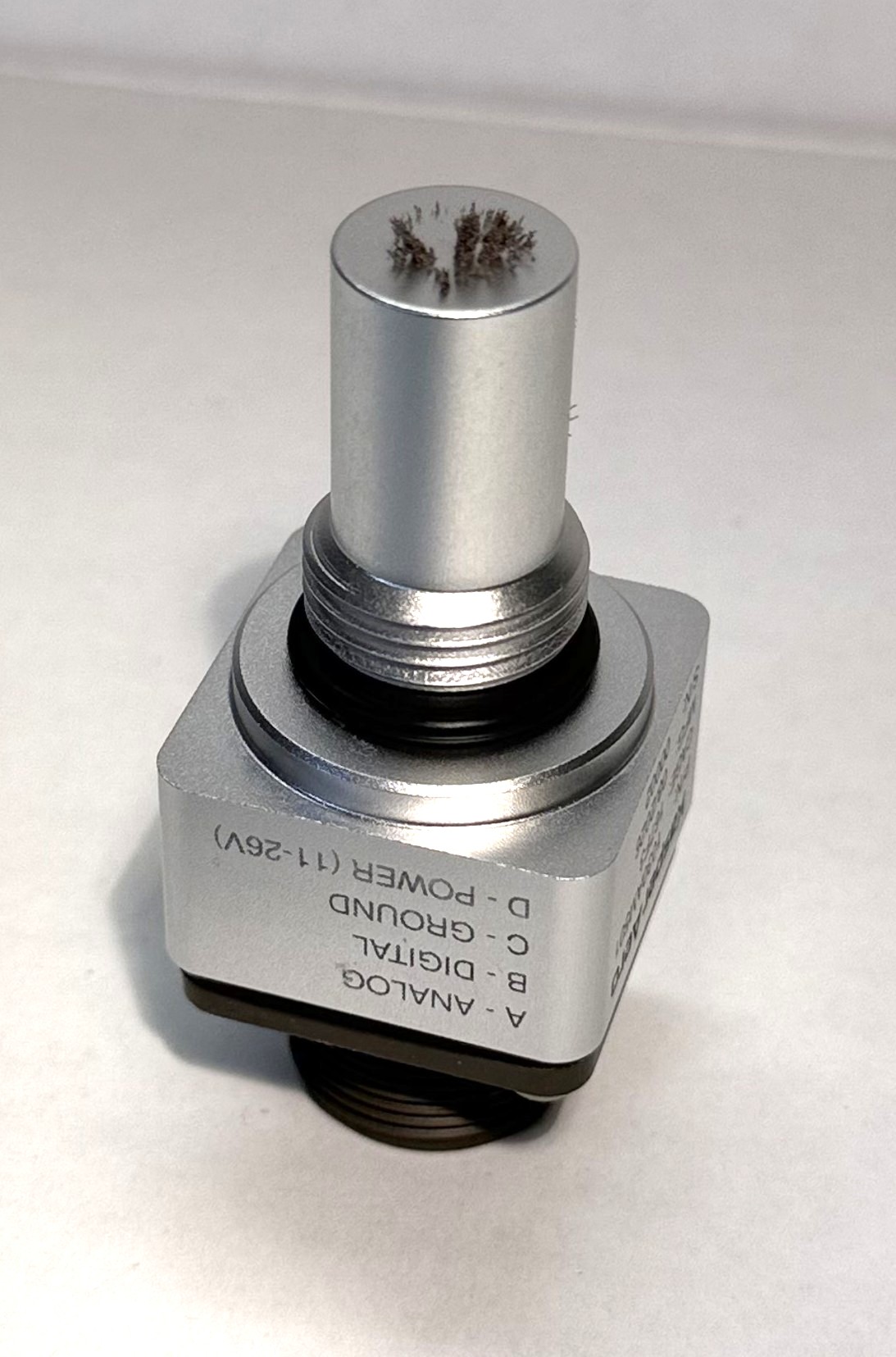 KasperAero 1030 debris sensor with approximately 10 mg of fine ferrous debris collected on its sensing face